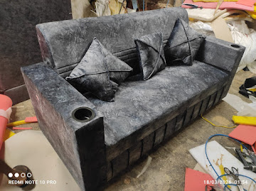 Grey textured sofa with armrest cup holders