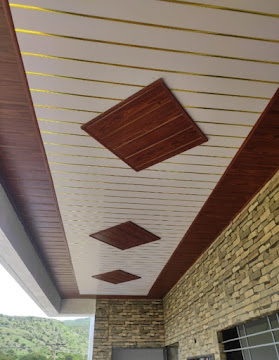 Finished residential exterior ceiling paneling with wood-grain borders