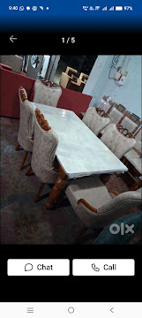 Marble top dining table with six upholstered chairs made by Andhra Furniture and Interiors